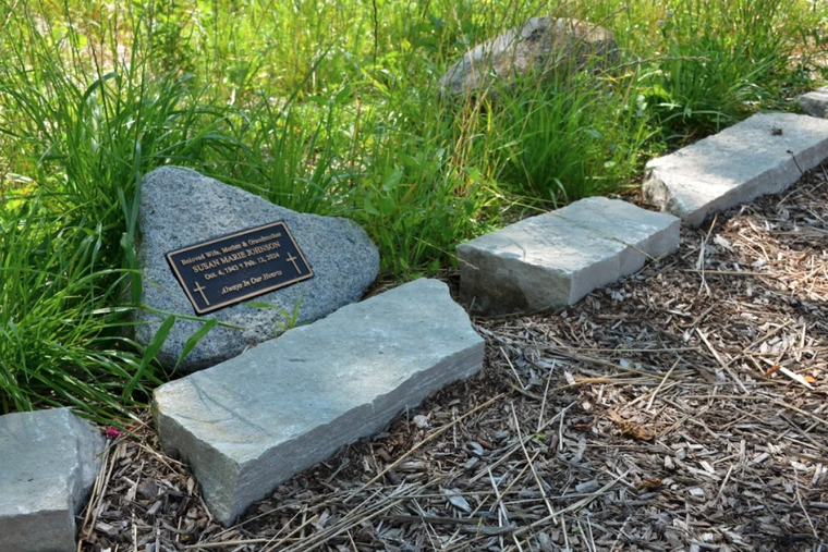 A grave marker in the Meadows of St. Kateri, the natural burial section at St. Michael the Archangel Cemetery in the Archdiocese of Chicago