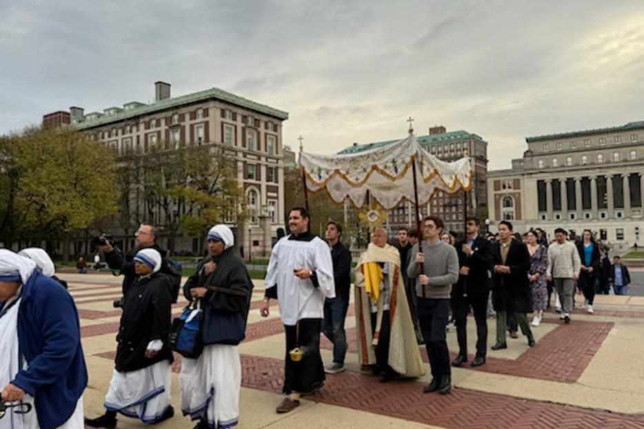 Father Roger Landry and a crowd of students take part in the Eucharistic procession on Columbia University Nov. 10, 2024.