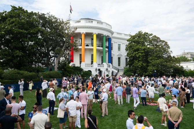 The pillars of the South Portico of the White House are decorated in rainbow colors as guests attend a White House Pride Month celebration on the South Lawn of the White House in Washington, D.C., on June 26, 2024.