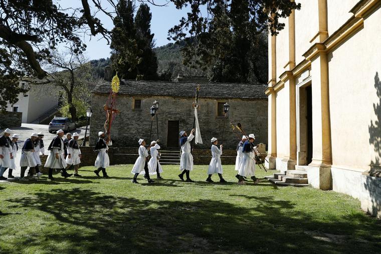 A confraternity or brotherhood collectively enters a church in Castello, on the French Mediterranean island of Corsica, on April 7, 2023.