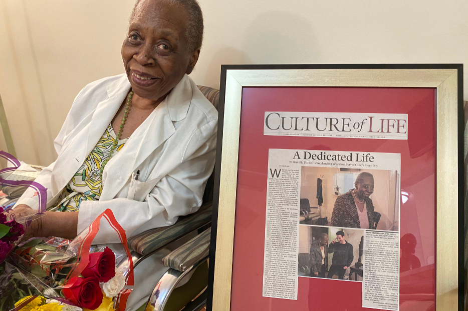 Dr. Melissa Freeman poses with the first article written about her life.