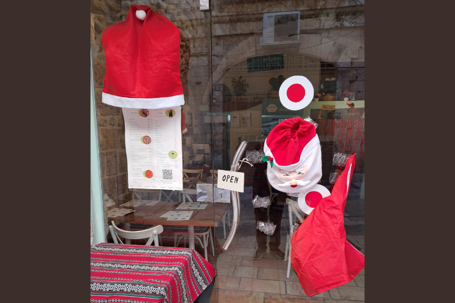 A restaurant in Jerusalem's Christian Quarter is decked out for Christmas,  but there are almost no tourists.
