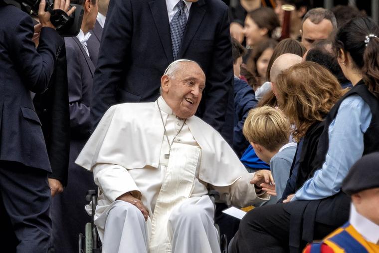 Pope Francis speaks with a child Oct. 16 after the Wednesday audience in St. Peter’s Square.