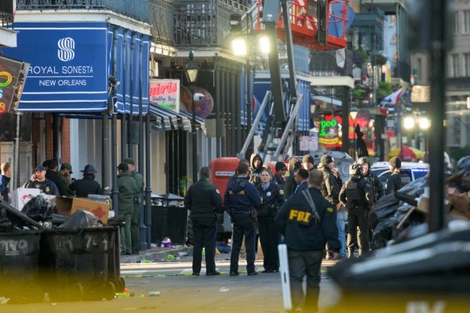 FBI investigators arrive at the scene where a pickup truck crashed into a work lift after allegedly driving into a crowd of New Year’s revelers in the French Quarter of New Orleans on Jan. 1, 2025.