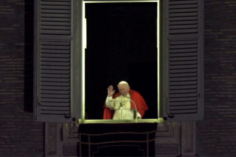 Pope John Paul II, in an unprecedented midnight appearance in his apartment window overlooking St. Peter’s Square, blesses worshippers gathered in St. Peter’s Square to celebrate the new millennium, early Saturday, Jan. 1, 2000.