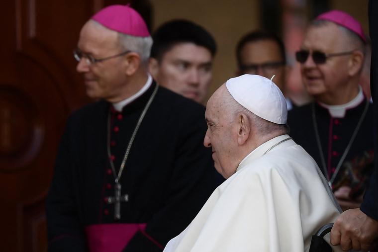 Pope Francis, flanked by Bishop Athanasius Schneider (l), the auxiliary bishop of Astana, Kazakhstan, arrives to meet with bishops, priests, deacons, consecrated persons, seminarians and pastoral workers in Our Lady of Perpetual Help Cathedral in Astana on Sept. 15, 2022.