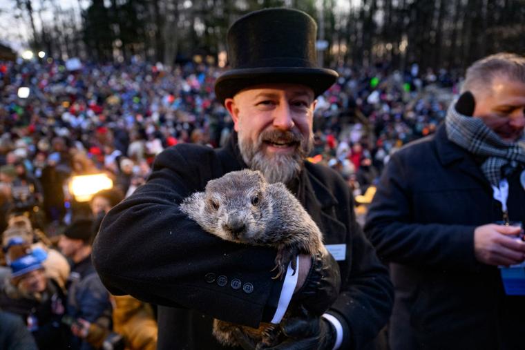Groundhog handler AJ Dereume, a Catholic, holds Punxsutawney Phil after he saw his shadow predicting 6 more weeks of winter during the 139th annual Groundhog Day festivities on Friday February 2, 2025 in Punxsutawney, Pennsylvania.
