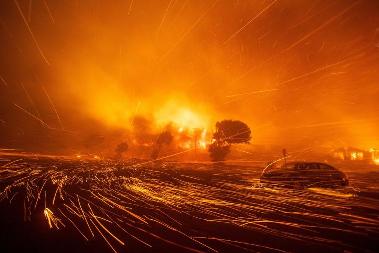 Strong winds whip embers into the air as the Palisades Fire rages during a fierce windstorm in Los Angeles, California
