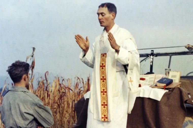 Father Emil Kapaun celebrates Mass using the hood of a Jeep as his altar on Oct. 7, 1950.