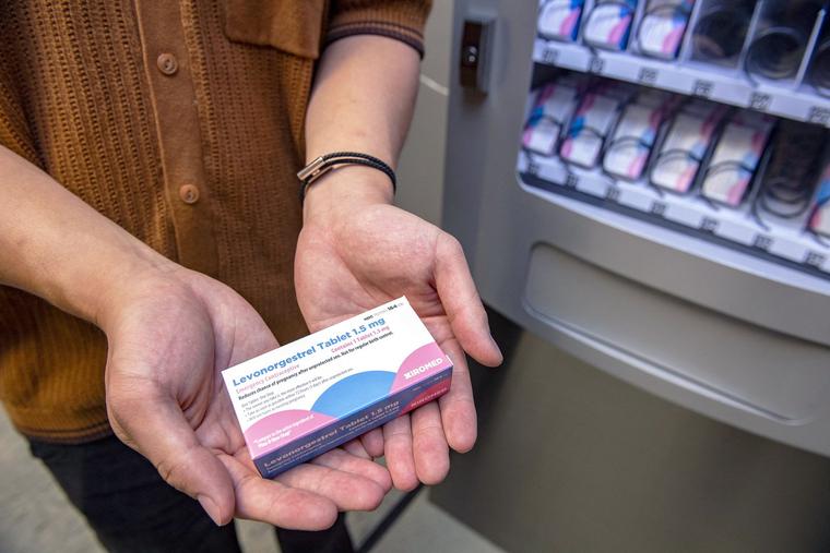 A person holds a carton of the “morning-after” pill purchased from a Plan B vending machine that sits in the basement of the student union building on the Boston University Campus in Boston, Massachusetts on July 26, 2022.