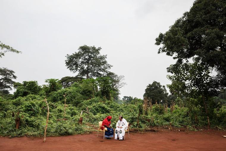 Spanish Bishop Juan-José Aguirre Muñoz of Bangassou, Central African Republic, hears the confession of a Catholic CAR refugee on Aug. 13, 2017, in Ndu, Democratic Republic of Congo.