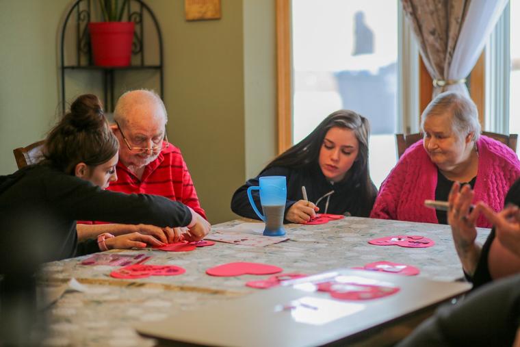 Catholic Charities Bureau (CCB) employees make valentines with elderly served by CCB.