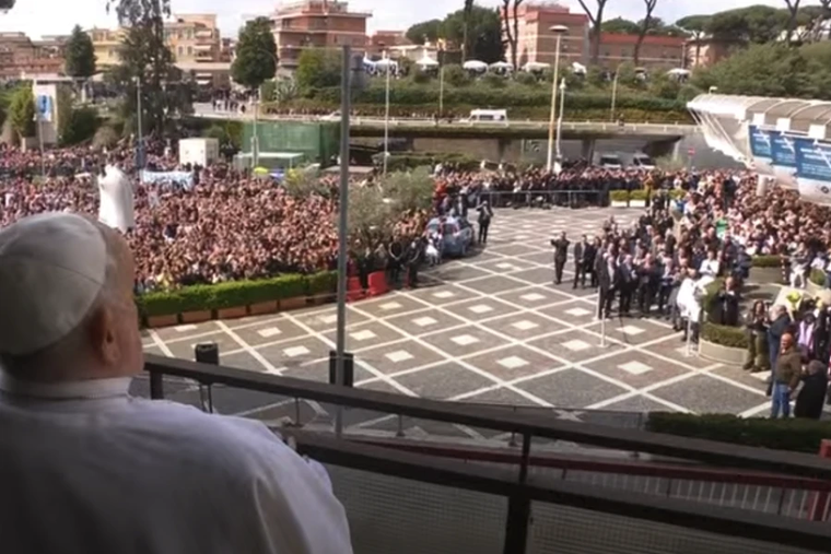 Pope Francis looks out at the crowd gathered below his hospital window at Rome's Gemelli Hospital on March 23, 2025.