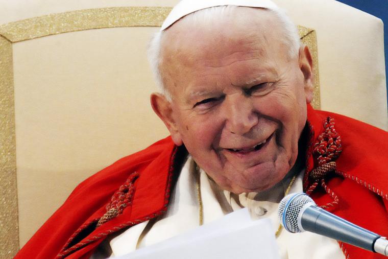 Pope John Paul II laughs during a gathering in St. Peter’s Square with tens of thousands of young people from Rome and the Lazio region, ahead of the 18th World Youth Day celebrations on Palm Sunday, April 13, 2003.