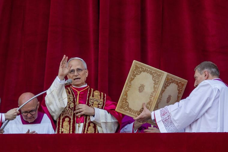 Pope Leo XIV offers his first blessing on May 8, 2025.