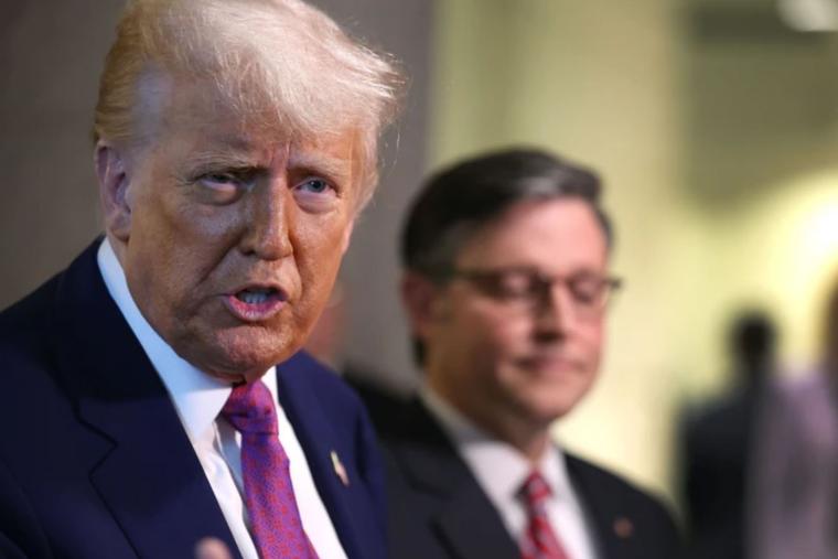 With Speaker of the House Mike Johnson by his side, President Donald Trump speaks to the press following a House Republican meeting at the U.S. Capitol on May 20, 2025, in Washington, D.C.