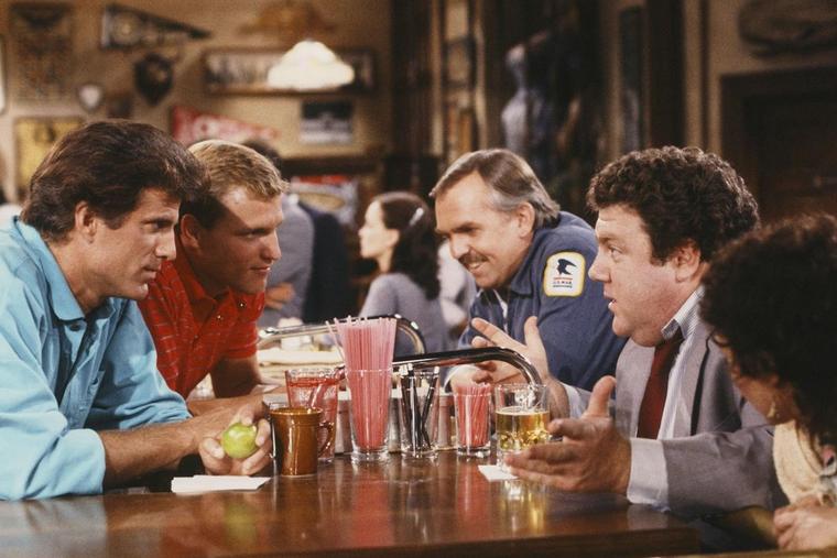 L to R: Ted Danson, Woody Harrelson, John Ratzenberger, George Wendt and Rhea Perlman in ‘Cheers’ (1982)