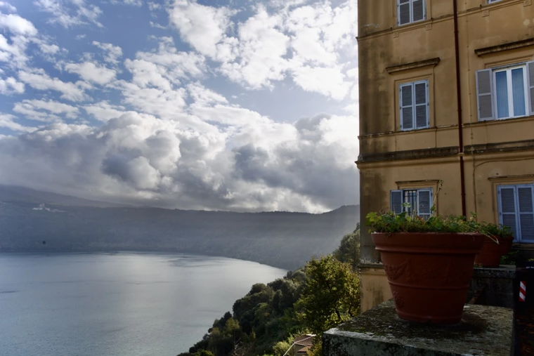 The Vatican Gardens at Castel Gandolfo is located on the wooded slopes of the Alban Hills, overlooking the blue waters of a small volcanic crater lake.