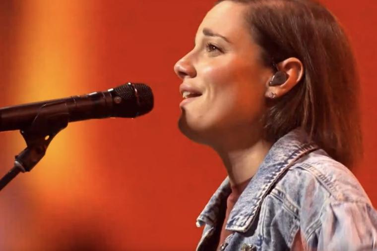 Sarah Kroger, a Catholic worship leader, takes part in leading the faithful in praise and worship at the National Eucharistic Congress in Indianapolis.