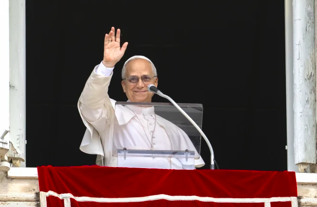 Pope Leo XIV waves to the crowd during his Angelus address on Aug. 24, 2025.