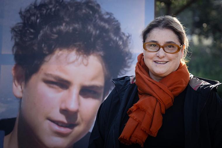 Antonia Salzano Acutis, mother of now-St. Carlo Acutis, an adolescent who spent his life spreading his faith online, earning the moniker ‘God’s Influencer,’ poses in front of a portrait of her son, in Assisi, Italy, on April 4, 2025.