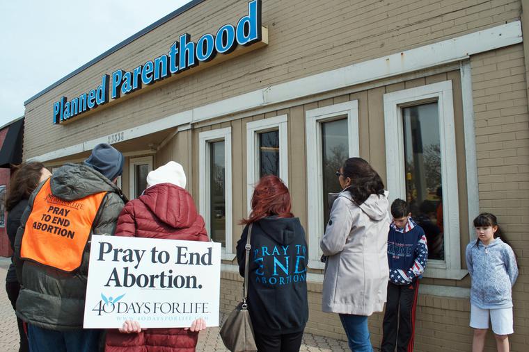 Pro-life community gathers outside a Planned Parenthood building, praying to end abortion in Ferndale, Michigan.