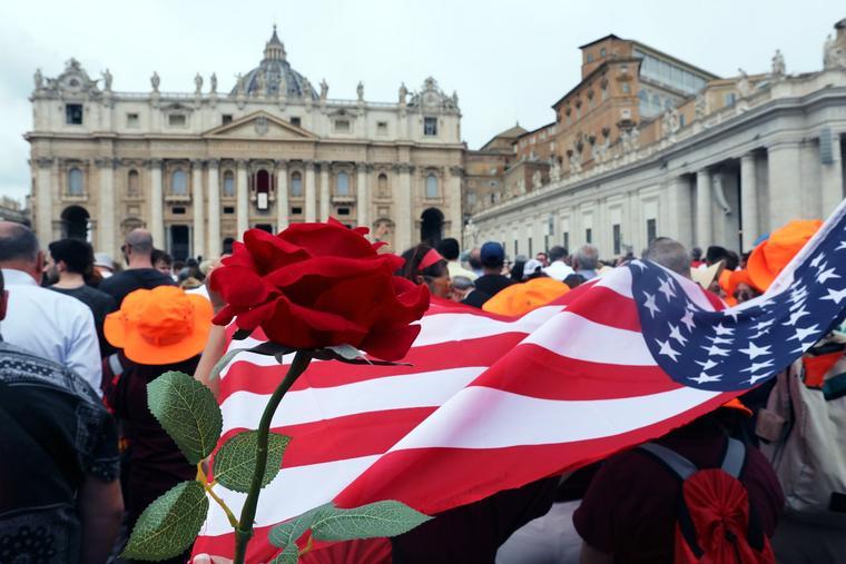 A red rose and U.S. flag are seen as thousands gather May 11 for the Regina Caeli in St. Peter's Square at the Vatican.