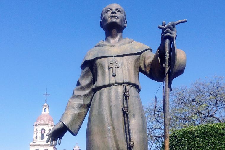 A bronze statue of Venerable Antonio Margil de Jesús (1657–1726), created by artist Alberto Pérez Soria, stands in front of Holy Cross Church in Querétaro, Mexico.