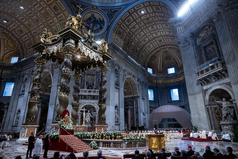 A view of St. Peter's Basilica during the Mass for the Solemnity of the Immaculate Conception, with Bernini's baldachin and the papal altar decorated with white flowers, Dec. 8, 2024.