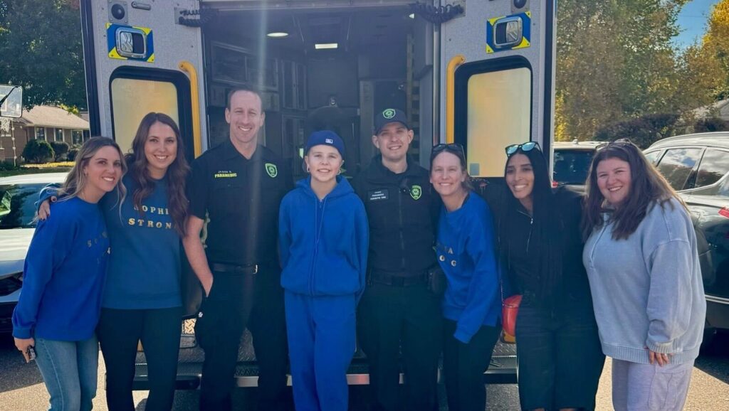 Sophia Forchas smiles with some of the first responders and friends gathered to welcome her as she stepped out of the hospital after 57 days.