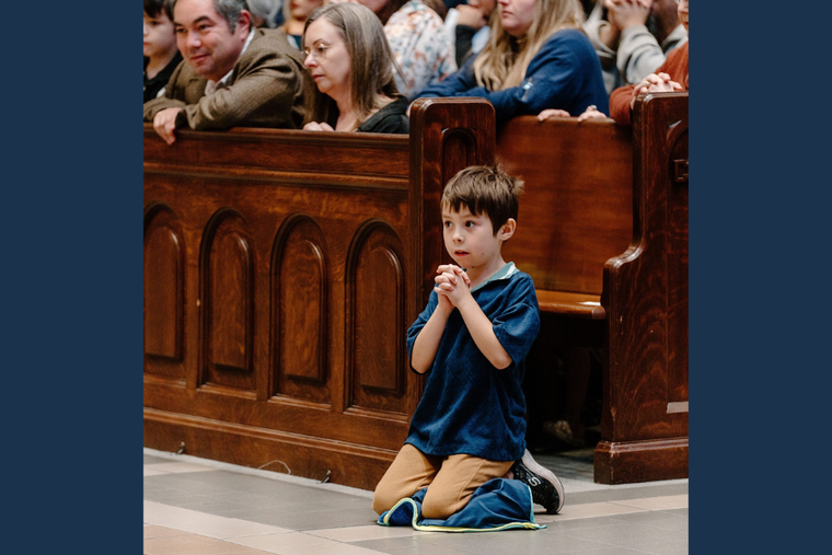 Emily Zanotti and her husband at Mass with one son captured praying piously by the Diocese of Nashville, Tenn.