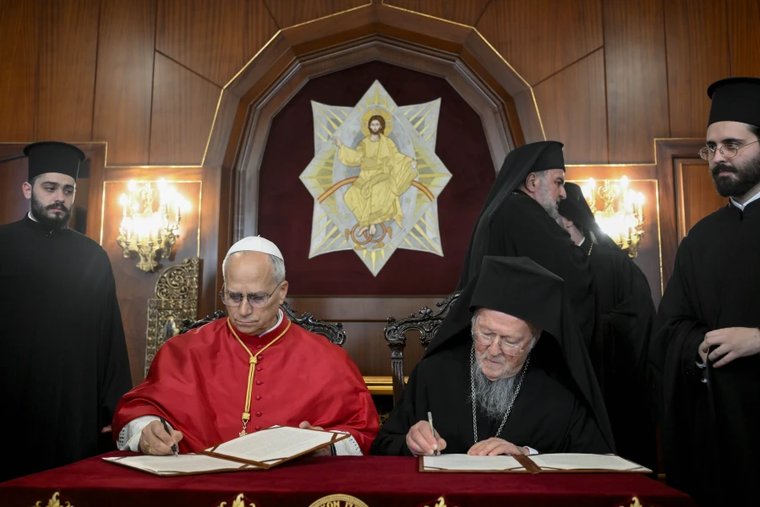 Pope Leo XIV and Ecumenical Patriarch Bartholomew I of Constantinople sign a joint declaration at the Palace of the Ecumenical Orthodox Patriarchate in Istanbul, Turkey, on Nov. 29, 2025.