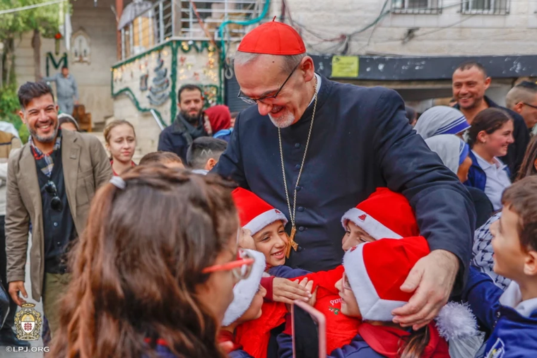 Children greet the Latin patriarch of Jerusalem, Cardinal Pierbattista Pizzaballa, during his visit to Gaza’s Holy Family Parish on Dec. 19, 2025.