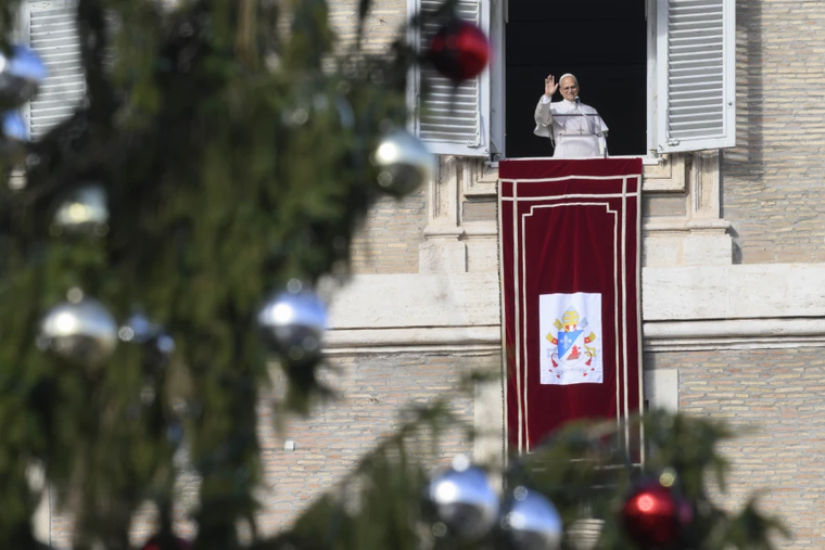Pope Leo XIV greets pilgrims gathered in St. Peter's Square at the Vatican for the recitation of the Angelus on Dec. 21, 2025.
