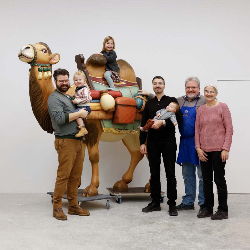 ALBL Family Camel Photo: Johannes Albl (left) and members of his family (including his brother, Markus, and his parents, Josef and Barbara Albl) pose alongside the camel they made as part of the life-size Great Nativity for Prince of Peace Catholic Church in Taylors, SC, which weighed over 1,600 pounds. (Photo: Courtesy of Johannes Albl)