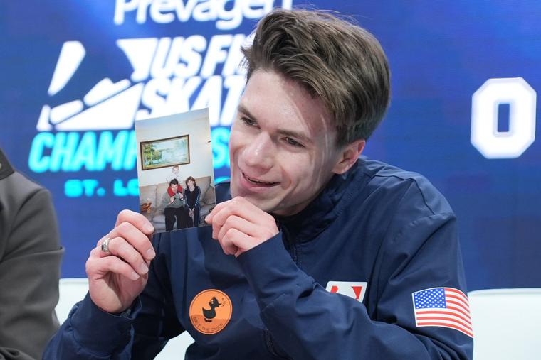 Maxim Naumov holds a family photo after competing during the men’s free skate competition at the U.S. Figure Skating Championships on Jan. 10, 2026, in St. Louis.