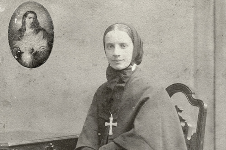 Mother Cabrini poses with the Sacred Heart of Jesus.