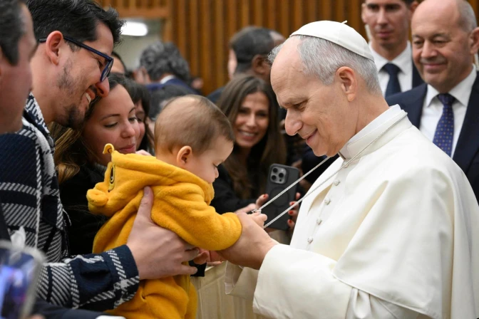 Pope Leo XIV greets a baby during a general audience at the Vatican.