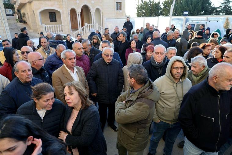 Residents gather outside the municipal hall to protest the death of the town’s pastor, killed by an Israeli shell in the southern Lebanese border town of Al-Qlayaa on Monday.