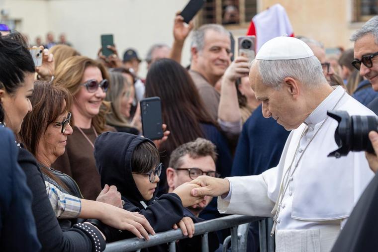 Pope Leo XIV greets members of the faithful at the Parish of the Sacred Heart of Jesus in Ponte Mammolo, a neighborhood on the outskirts of Rome, on March 15, 2026.