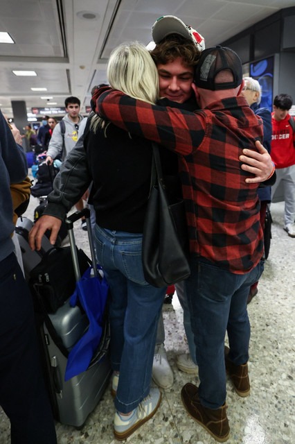 Aidan Korn hugs his parents, Karen and Jason Korn, at Dulles Airport in Virginia upon his safe return, Thursday, March 5, 2026 | Credit: Courtesy of the Korn family