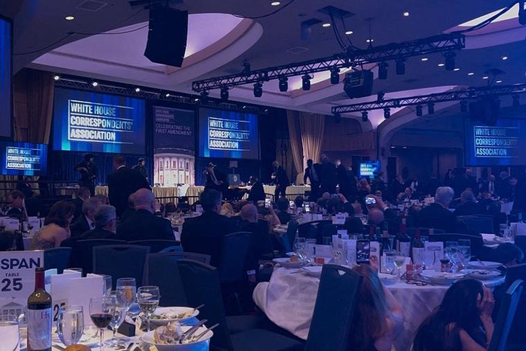 A screen grab taken from a video filmed by an AFP reporter shows armed agents moving to the stage after loud bangs were heard during the White House Correspondents' Dinner at the Washington Hilton in Washington on April 25, 2026.