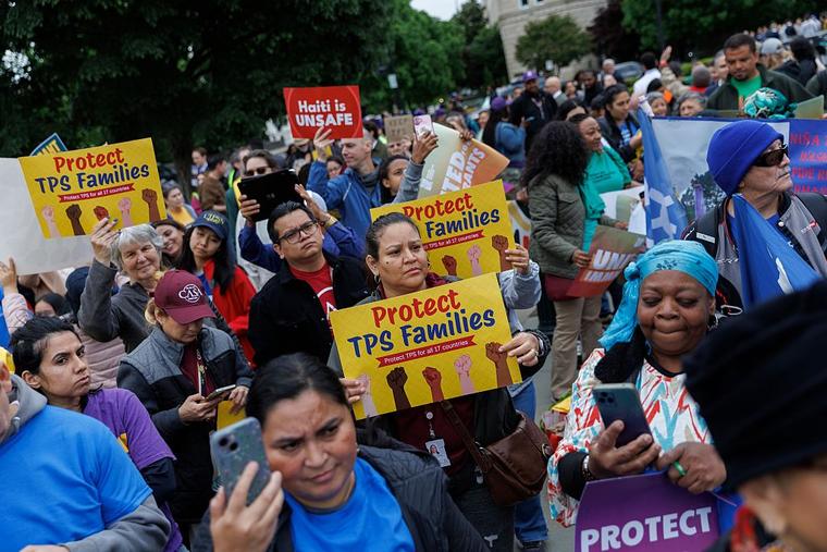 Demonstrators chant and hold signs outside U.S. Supreme Court on April 29, 2026, in Washington, D.C. The court heard arguments challenging the government’s termination of temporary protected status for asylum seekers.