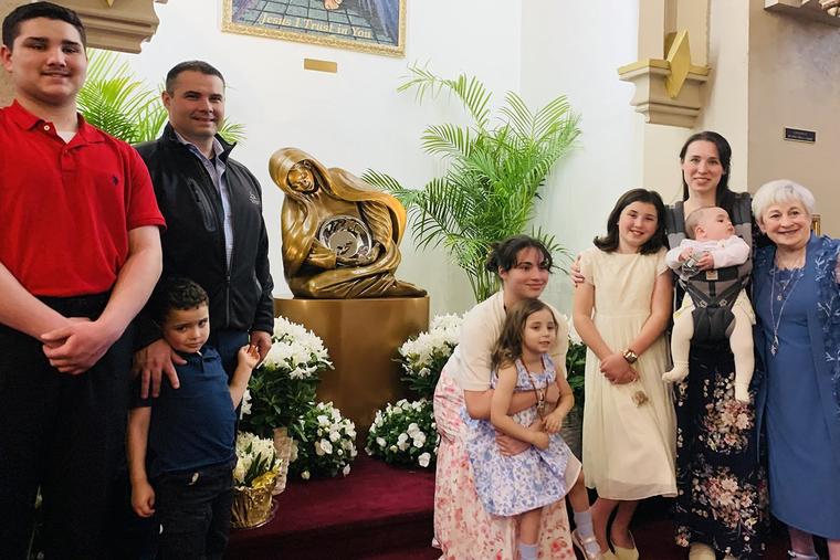 Parishioners gather in front of the ‘Life’ sculpture at All Saints Parish in Haverhill, Massachusetts.
