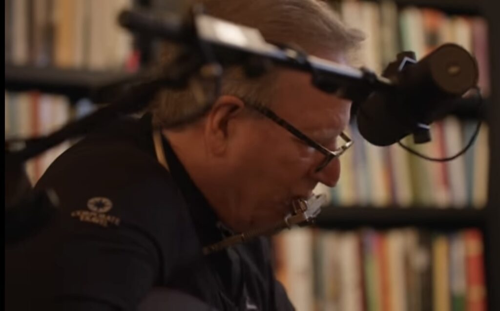 Bishop Barron plays harmonica at home playing a Bob Dylan song.