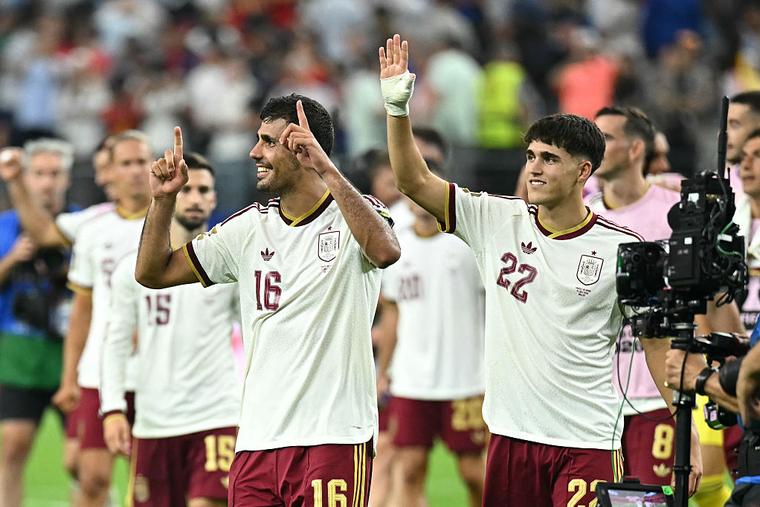 Spain's midfielder #16 Rodri and defender #22 Pau Cubarsi celebrate after their team won the 2026 World Cup football tournament semi-final match between France and Spain at the Dallas Stadium in Arlington on July 14, 2026.