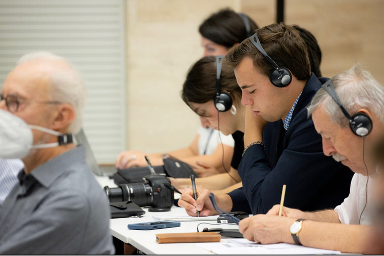 Jack Figge, shown as a student journalist, attends a past press conference at the Vatican.
