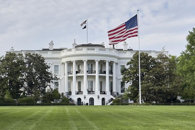 The view of the White House from the South Lawn with the U.S. flag is seen on April 18, 2026.
