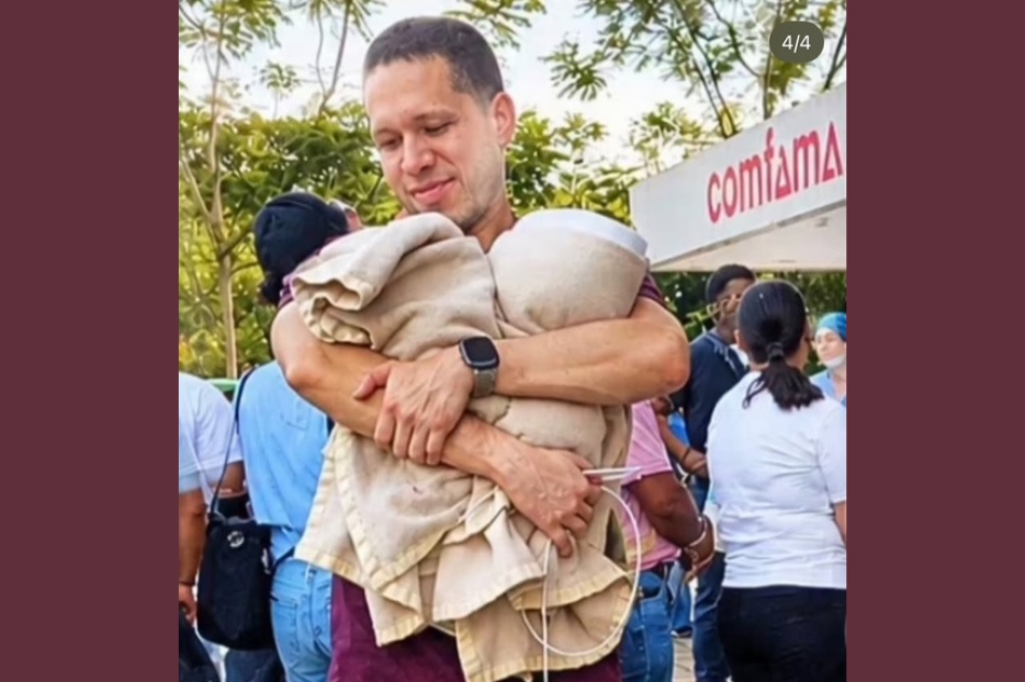 Dr. Germán Andres Somoyar gazes down at two infants that were rescued amid the terrifying earthquake that shook Colombia.