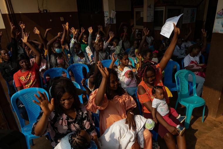 Mothers with their children listen to a nurse giving advice at a hospital in Soa, Cameroon, on Jan. 22, 2024.